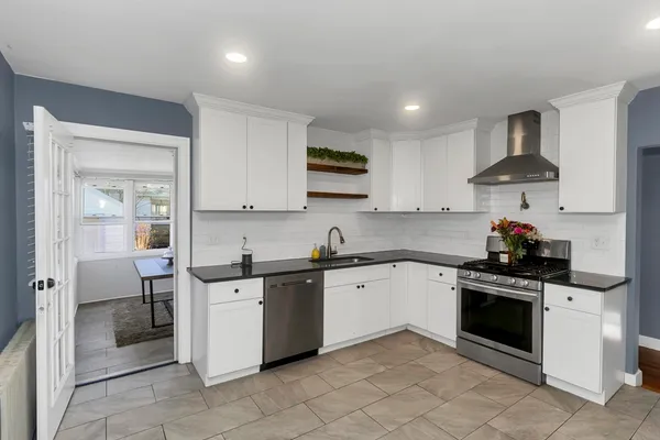 a kitchen with stainless steel appliances granite countertop a sink and a stove