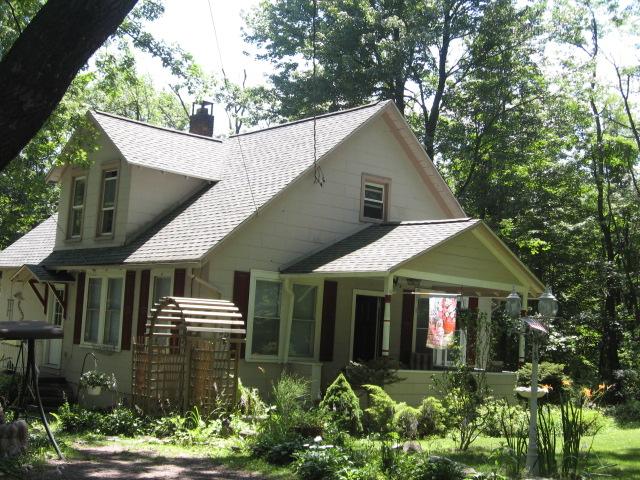 65 Reeder Street Mount Pocono, PA 18344 - Photo 1 of 9 a front view of a house with garden