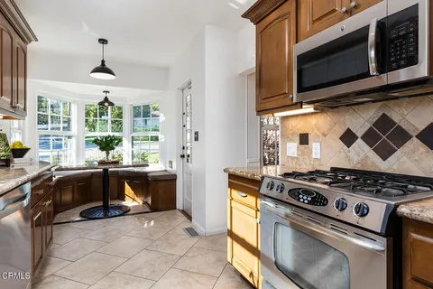 a view of a kitchen that has a sink and a window