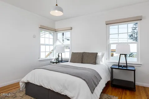 a bathroom with a granite countertop sink a toilet and a mirror
