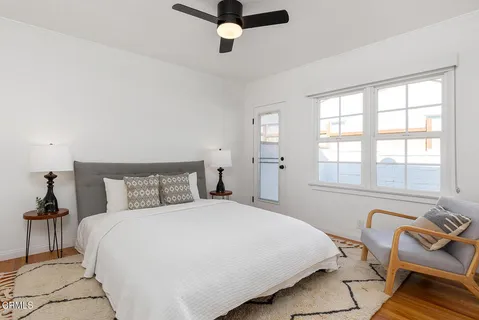 a view of a workspace with furniture and wooden floor