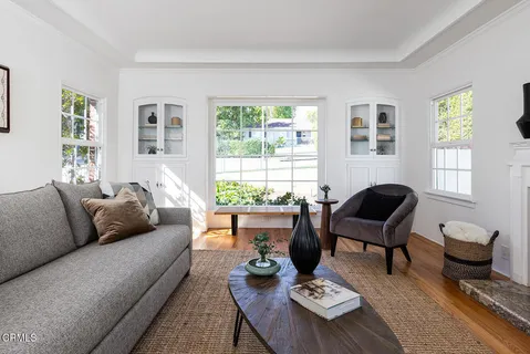 a balcony view with a large window and wooden floor