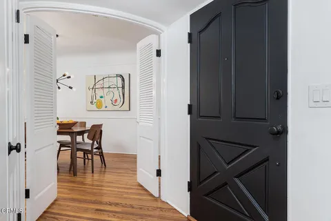 a view of a dining room with furniture and wooden floor