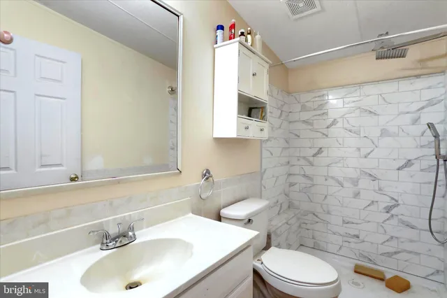 a bathroom with a sink a toilet and shower curtain