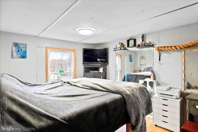 a bedroom with a bed and a couch