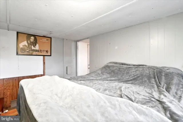 a living room with lots of furniture and clothes