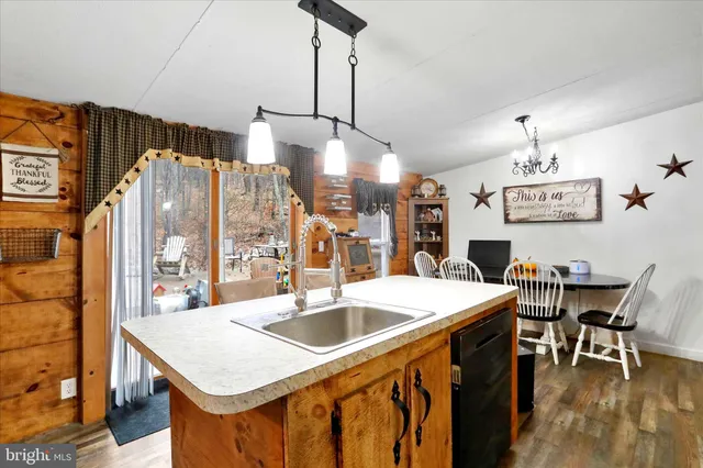 a kitchen that has a table chairs and a wooden floor