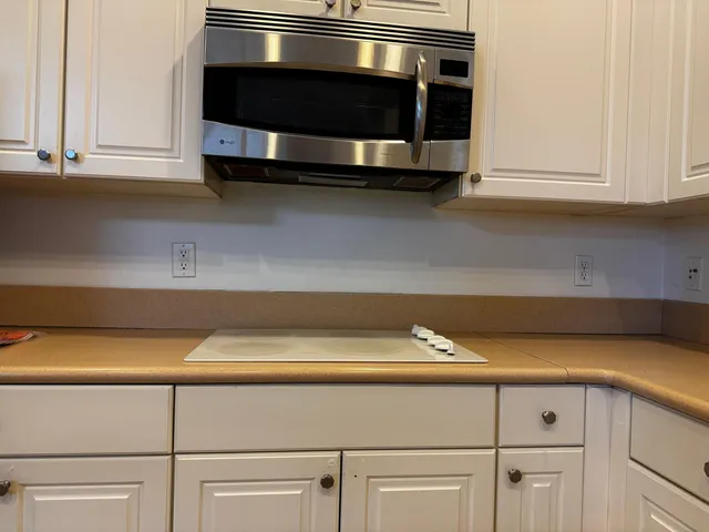 a kitchen with appliances and cabinets