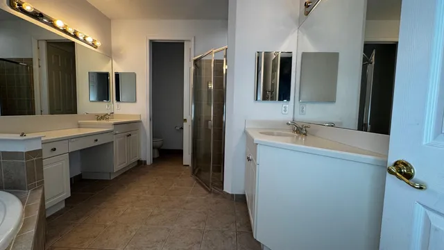 a bathroom with a double vanity sink and mirror