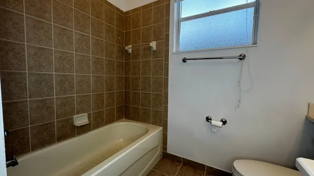 a bathroom with a toilet a sink and bathtub