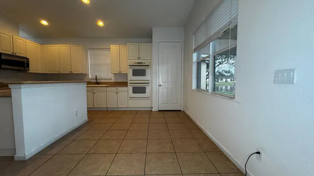 a kitchen with stainless steel appliances a refrigerator sink and microwave