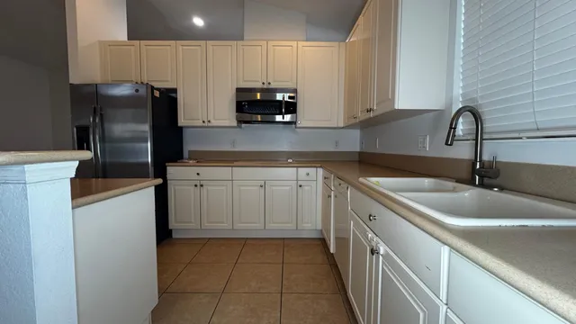 a kitchen with a sink stove and refrigerator