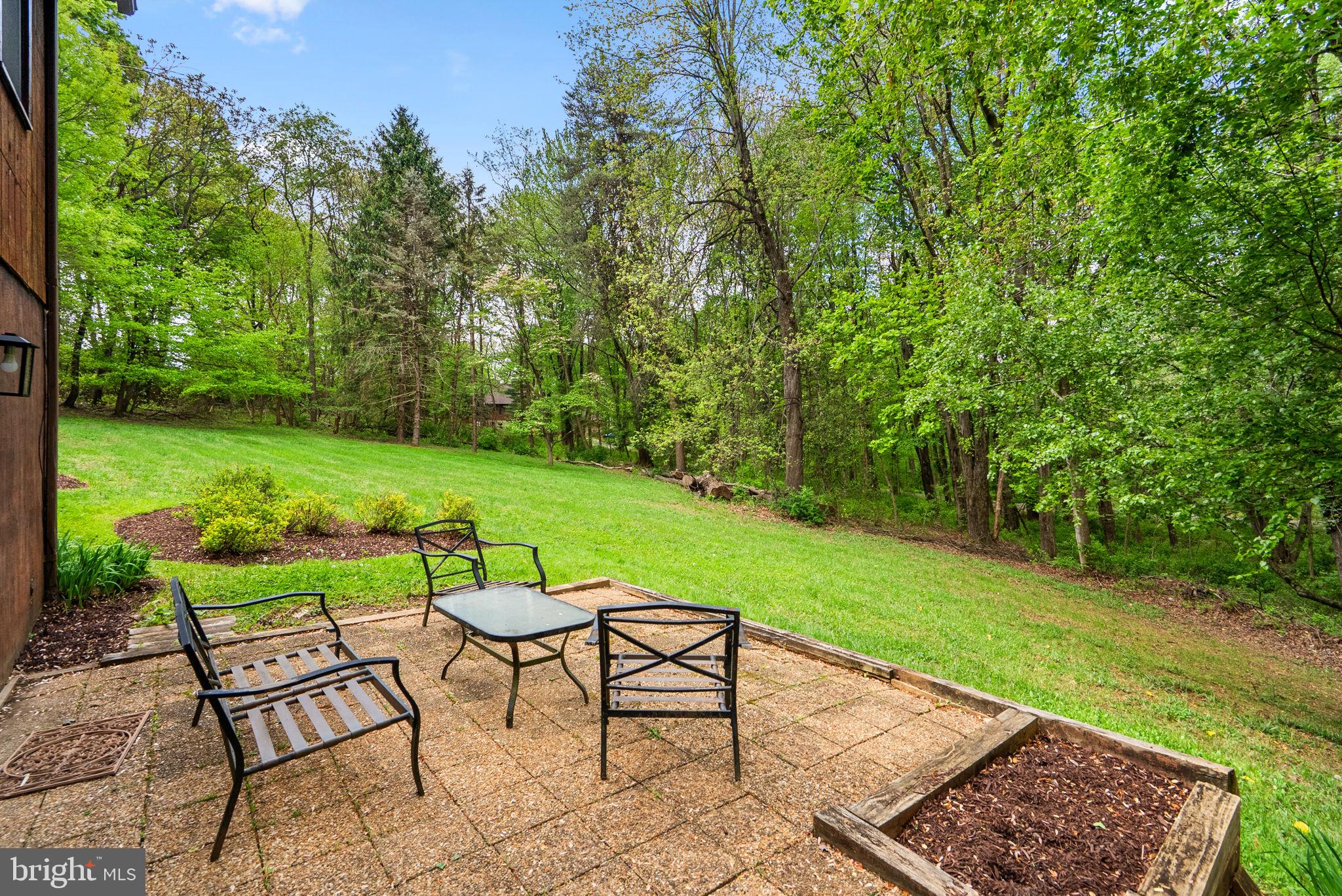 12410 Piedmont Road Clarksburg, MD 20871 - Photo 53 of 64 Serene patio with lush green backdrop.