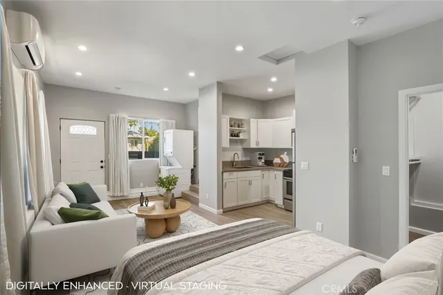 a bedroom with a bed and a view of kitchen