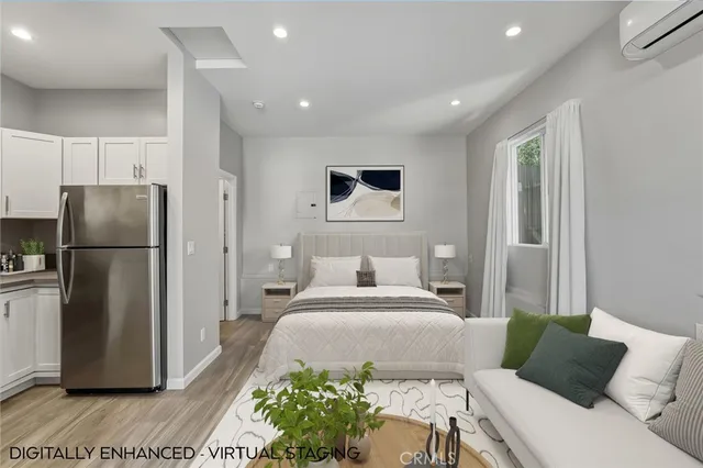 a bedroom with a bed and a refrigerator