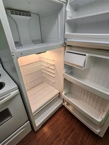 a kitchen with a stainless steel appliances a refrigerator and a microwave
