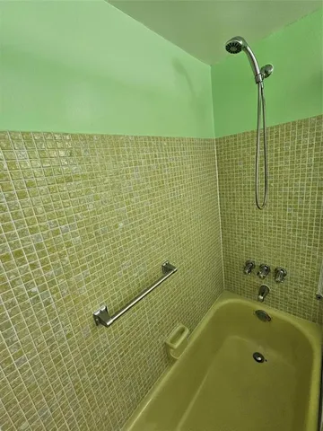 a living room with couch and a wooden floor