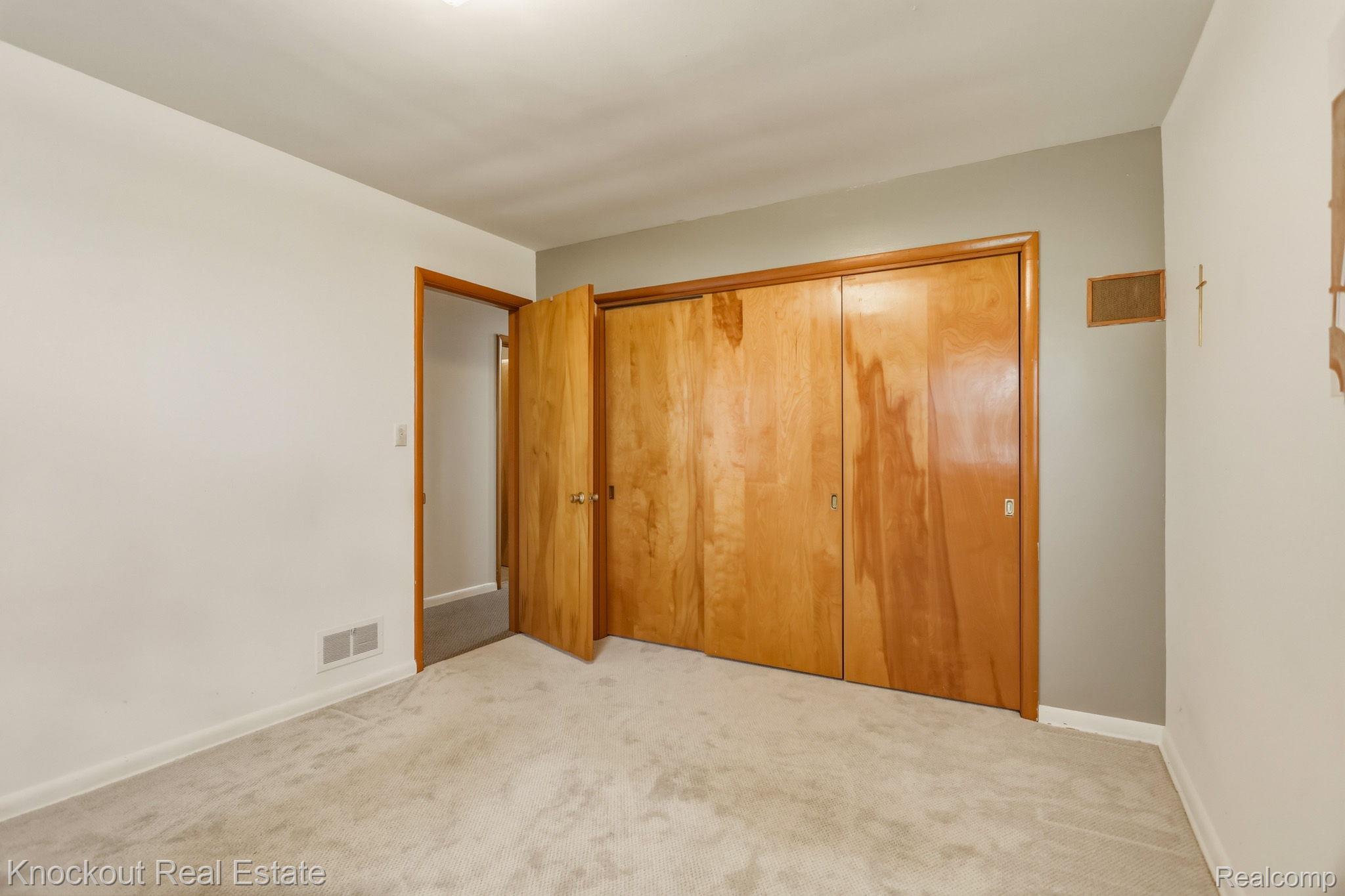 1755 South Reese Road Reese, MI 48757 - Photo 21 of 69 Light-toned carpeting, wood-finish doors, and a neutral color palette