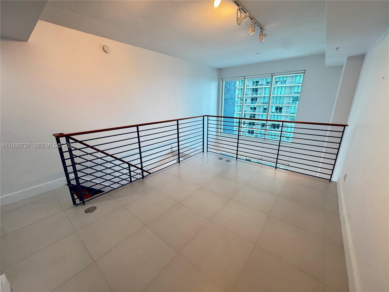 60 Southwest 13th Street, Unit 2606 Miami, FL 33130 - Photo 11 of 15 an empty room with windows