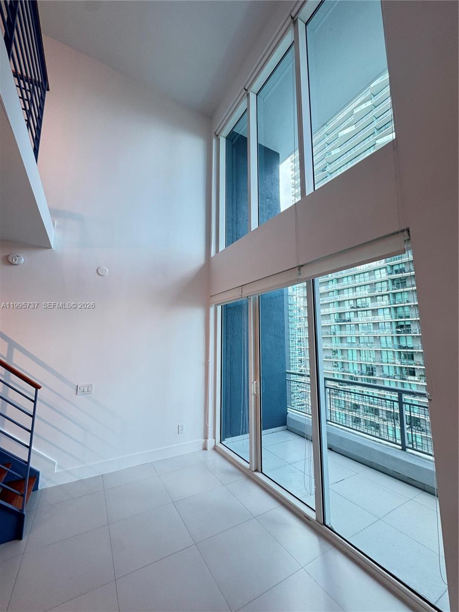 60 Southwest 13th Street, Unit 2606 Miami, FL 33130 - Photo 13 of 15 a view of an empty room with a balcony