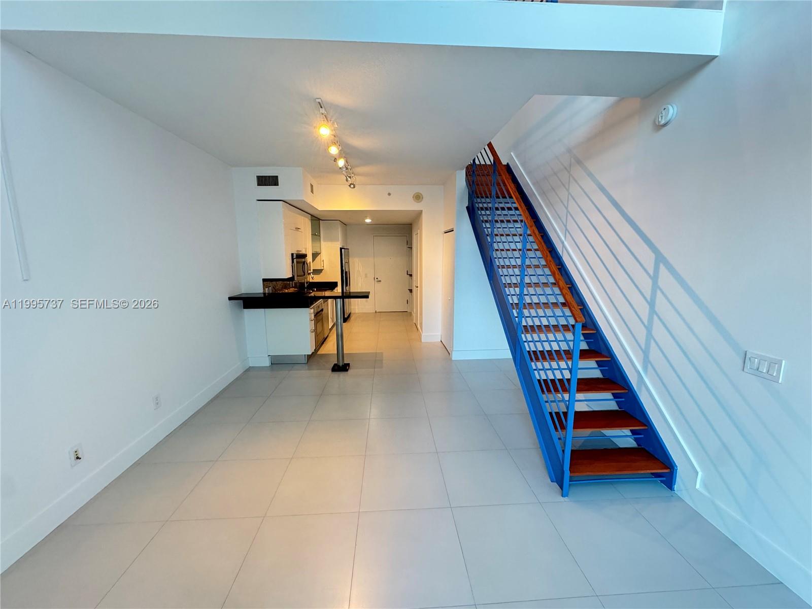 60 Southwest 13th Street, Unit 2606 Miami, FL 33130 - Photo 4 of 15 a view of hallway with stairs and furniture