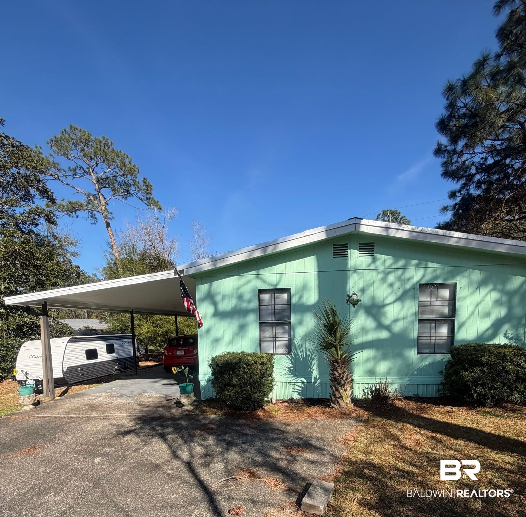1430 Ridgewood Drive Lillian, AL 36549 - Photo 1 of 34 View of front of home with an attached carport and asphalt driveway