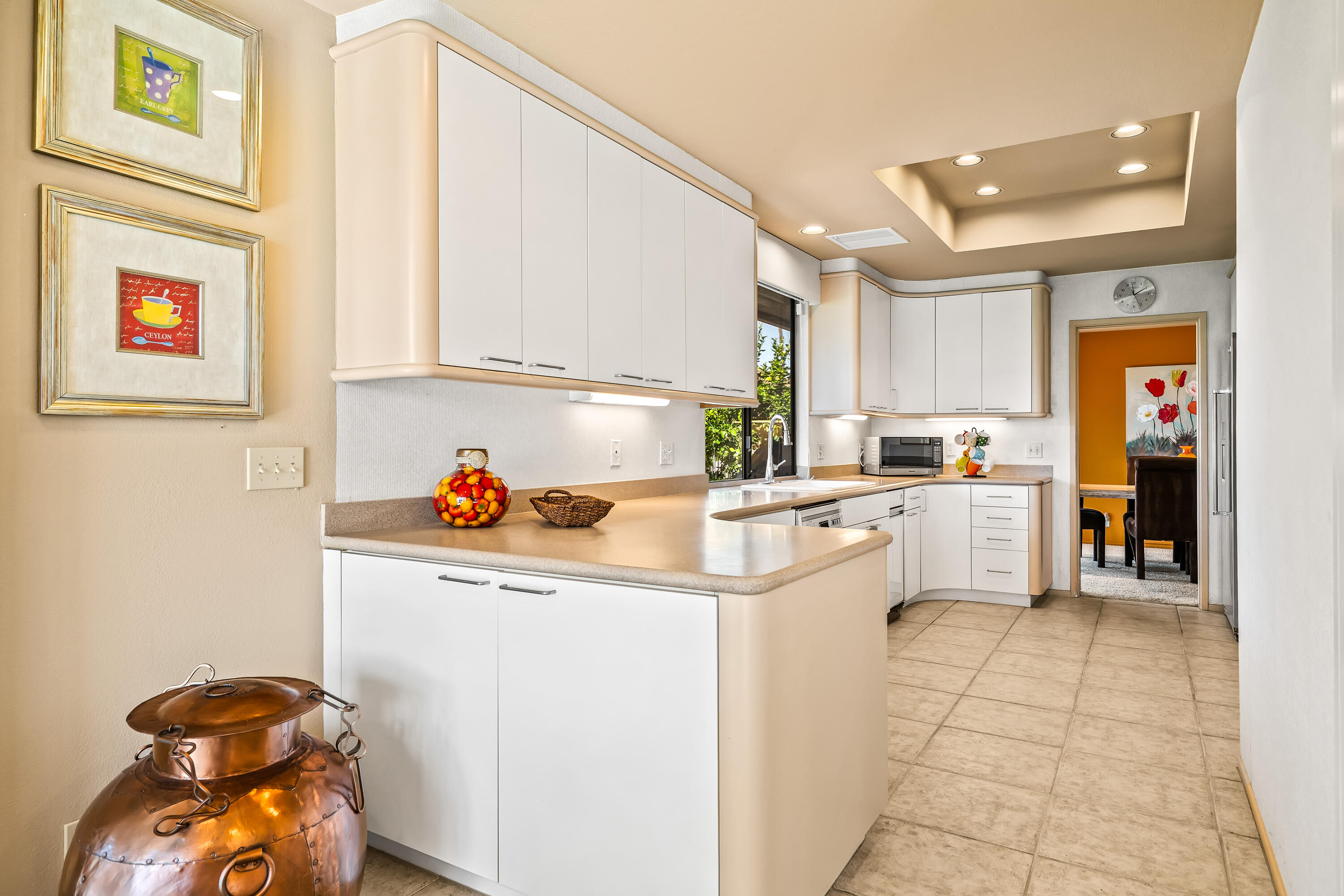 47 Columbia Drive Rancho Mirage, CA 92270 - Photo 14 of 59 a kitchen with a white cabinets and white appliances