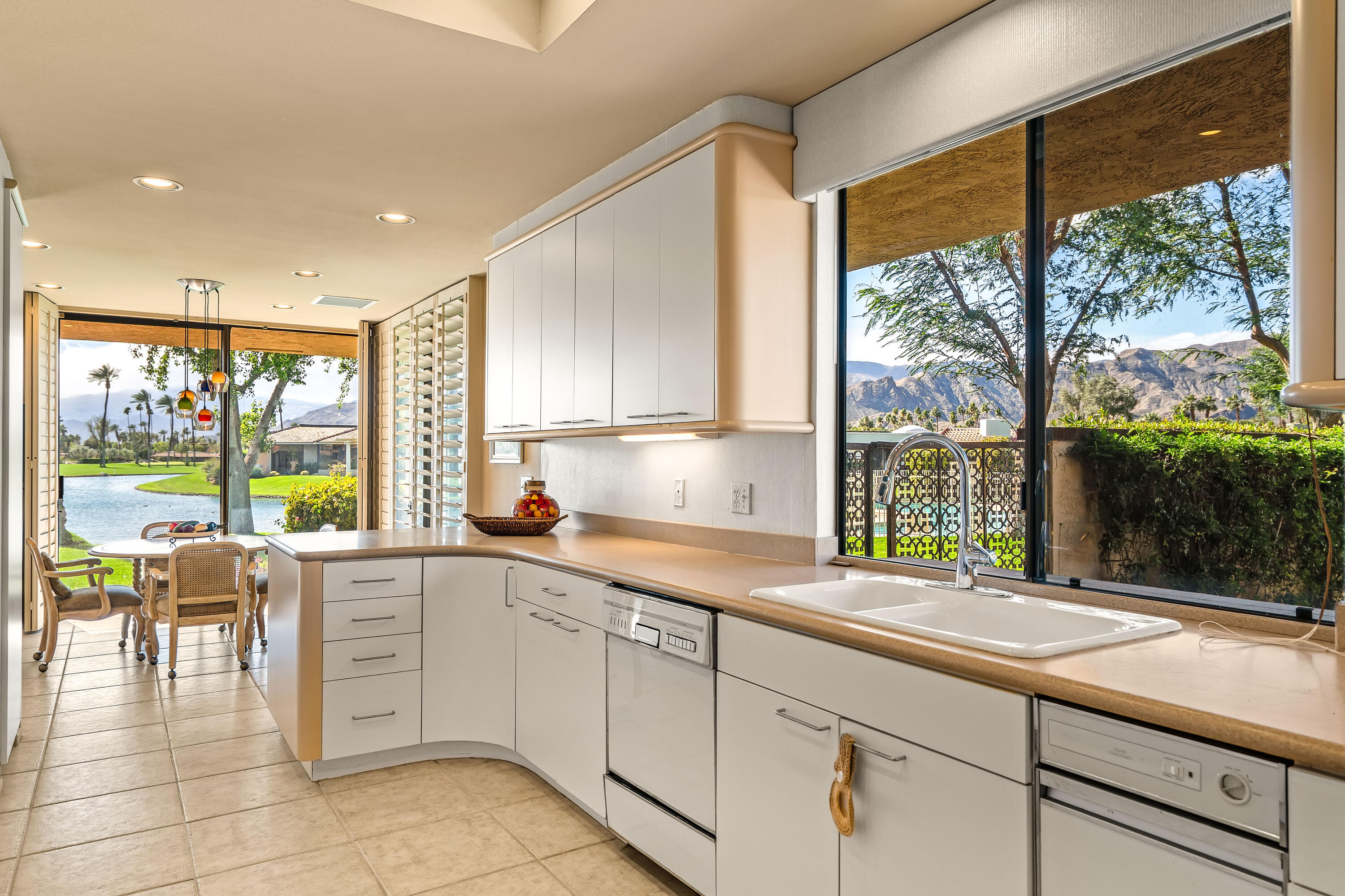 47 Columbia Drive Rancho Mirage, CA 92270 - Photo 15 of 59 a kitchen with a sink and large window
