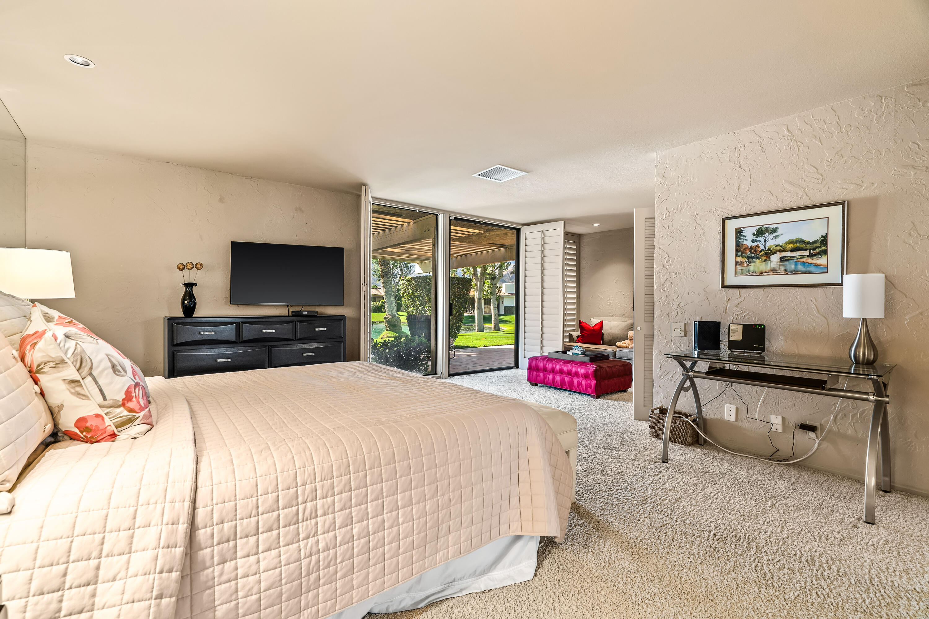 47 Columbia Drive Rancho Mirage, CA 92270 - Photo 21 of 59 a bedroom with a bed and a flat screen tv