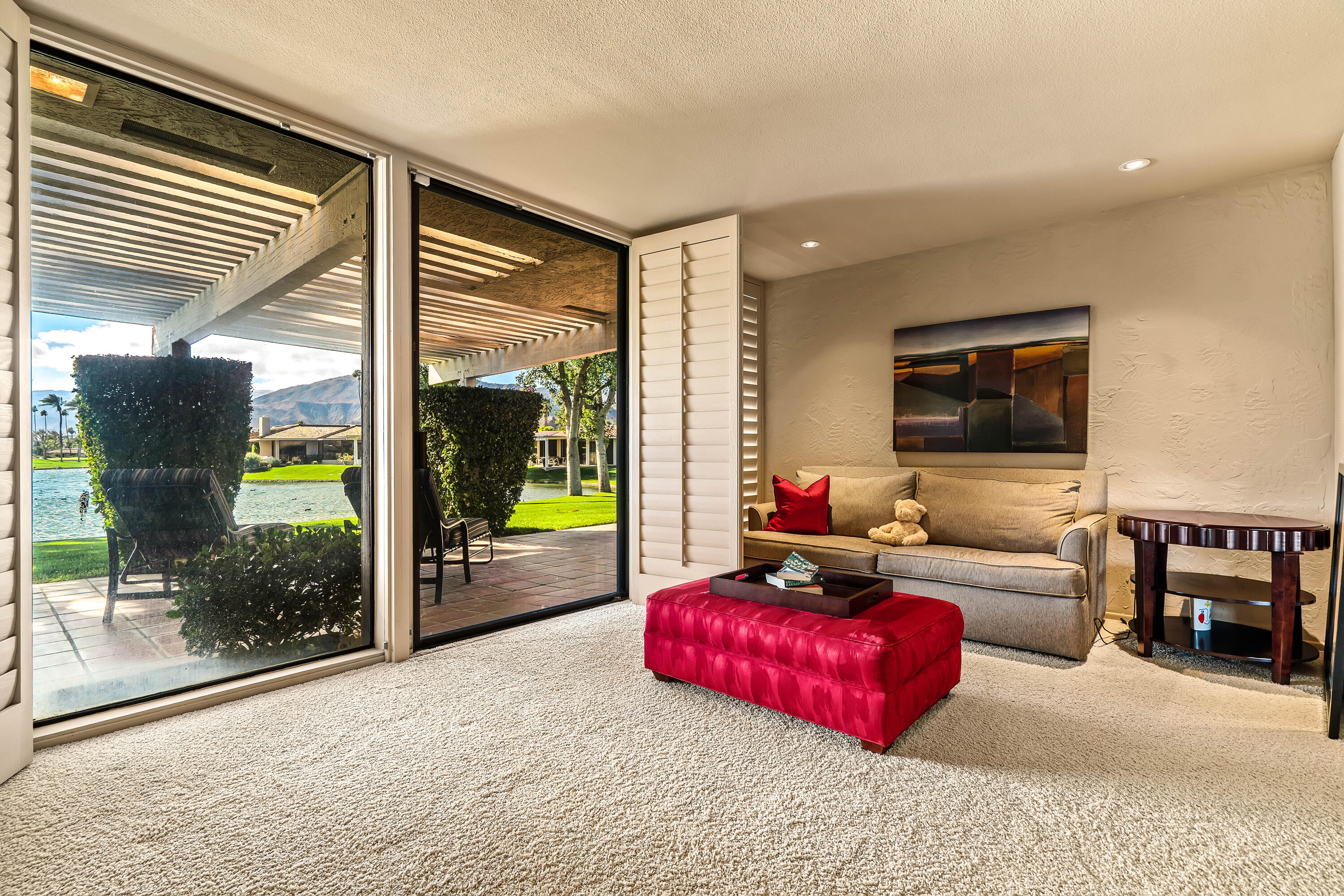 47 Columbia Drive Rancho Mirage, CA 92270 - Photo 23 of 59 a living room with furniture a large window and a flat screen tv