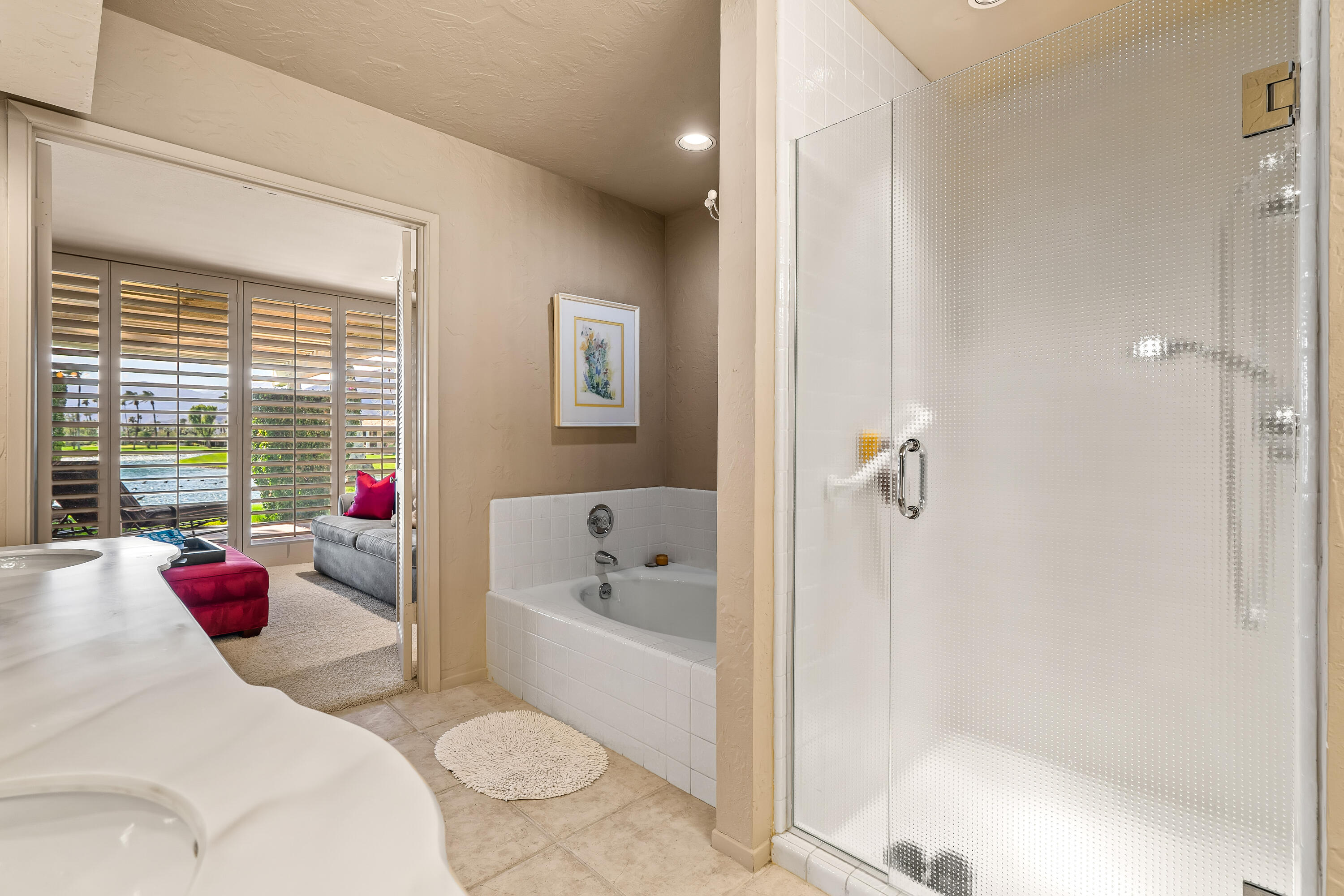 47 Columbia Drive Rancho Mirage, CA 92270 - Photo 25 of 59 a bath tub sitting next to a white sink and a shower