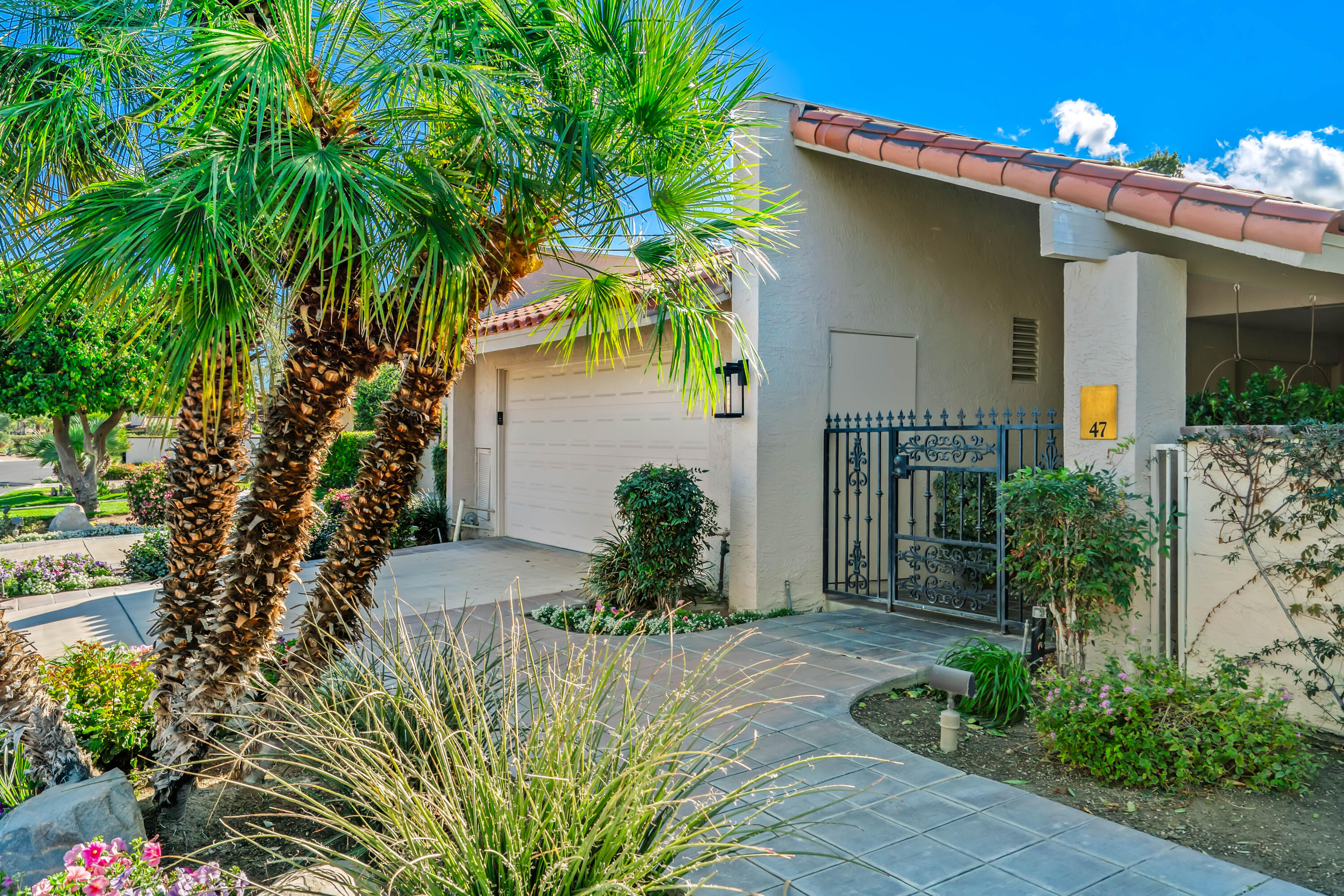 47 Columbia Drive Rancho Mirage, CA 92270 - Photo 30 of 59 a front view of a house with a yard