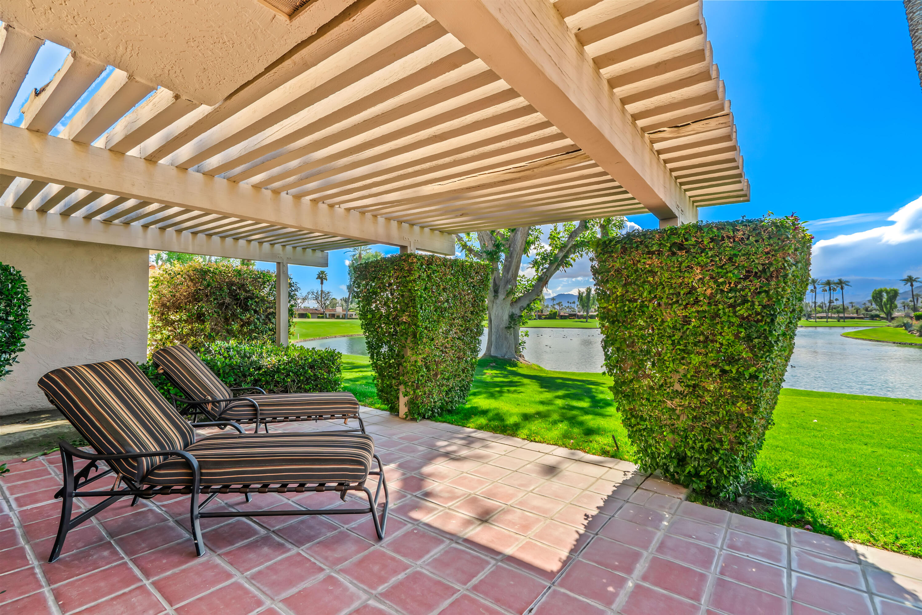47 Columbia Drive Rancho Mirage, CA 92270 - Photo 45 of 59 a view of a patio with table and chairs and potted plants