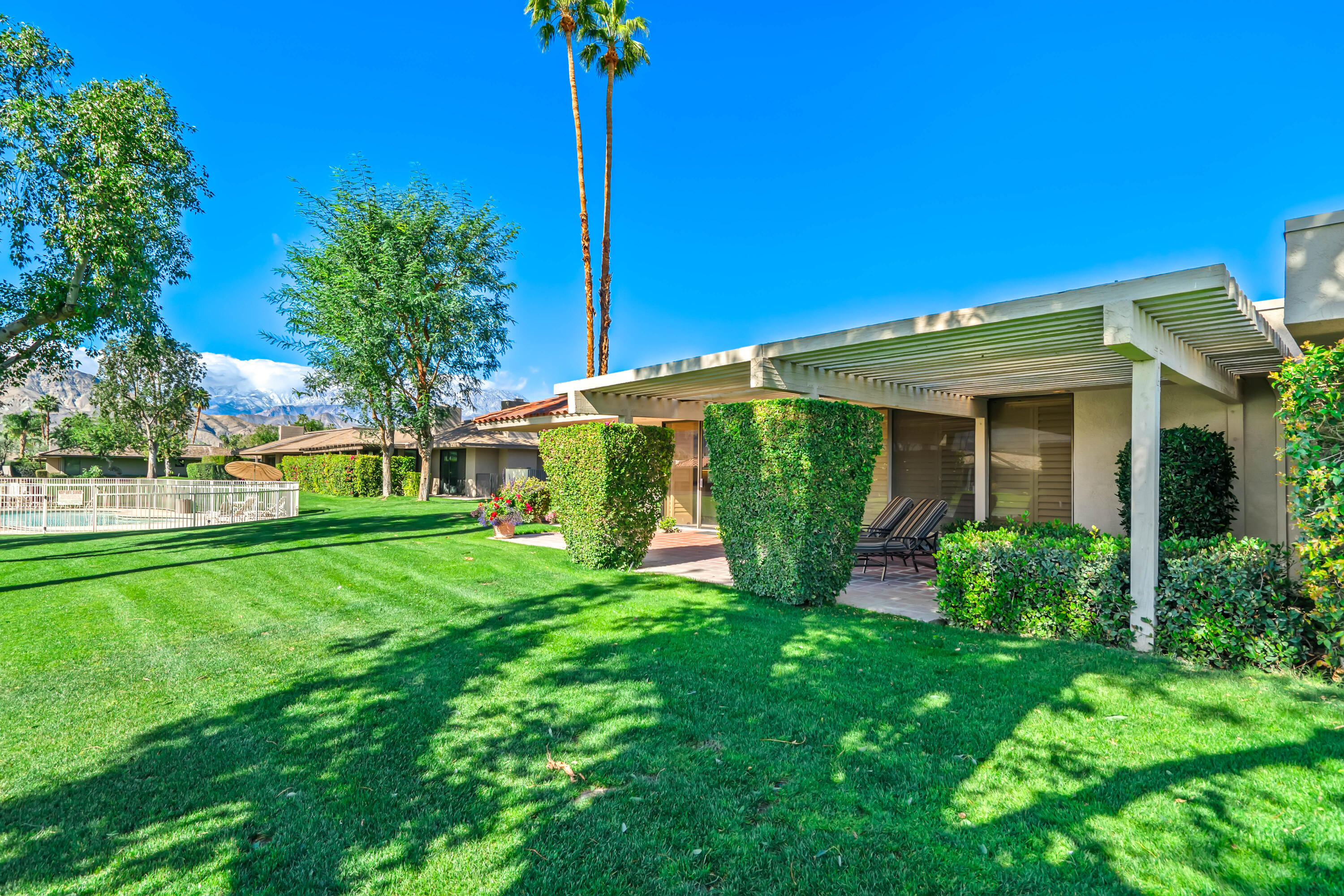 47 Columbia Drive Rancho Mirage, CA 92270 - Photo 47 of 59 a view of a house with a yard and potted plants