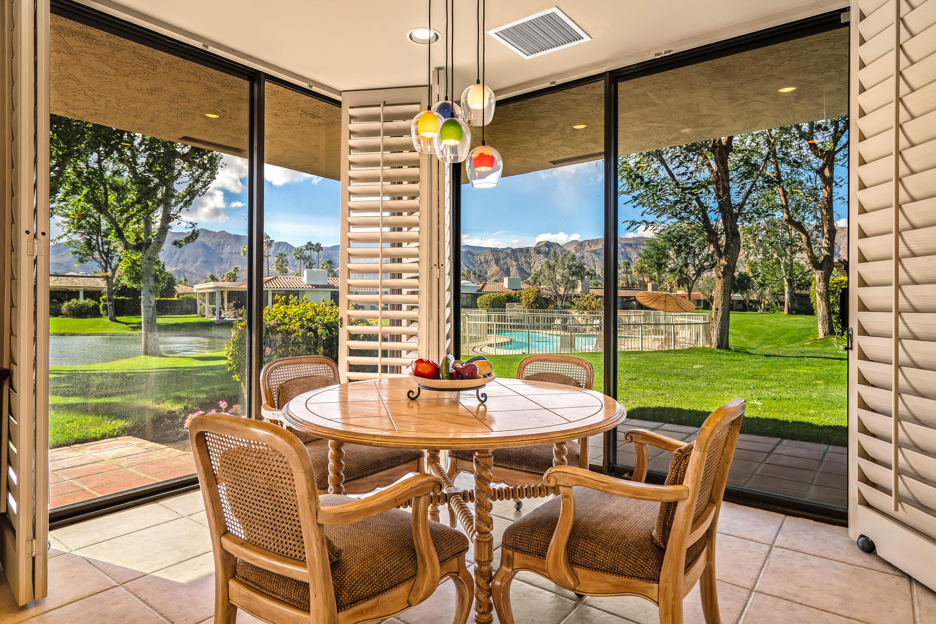 47 Columbia Drive Rancho Mirage, CA 92270 - Photo 5 of 59 a dining area with glass top table and chairs