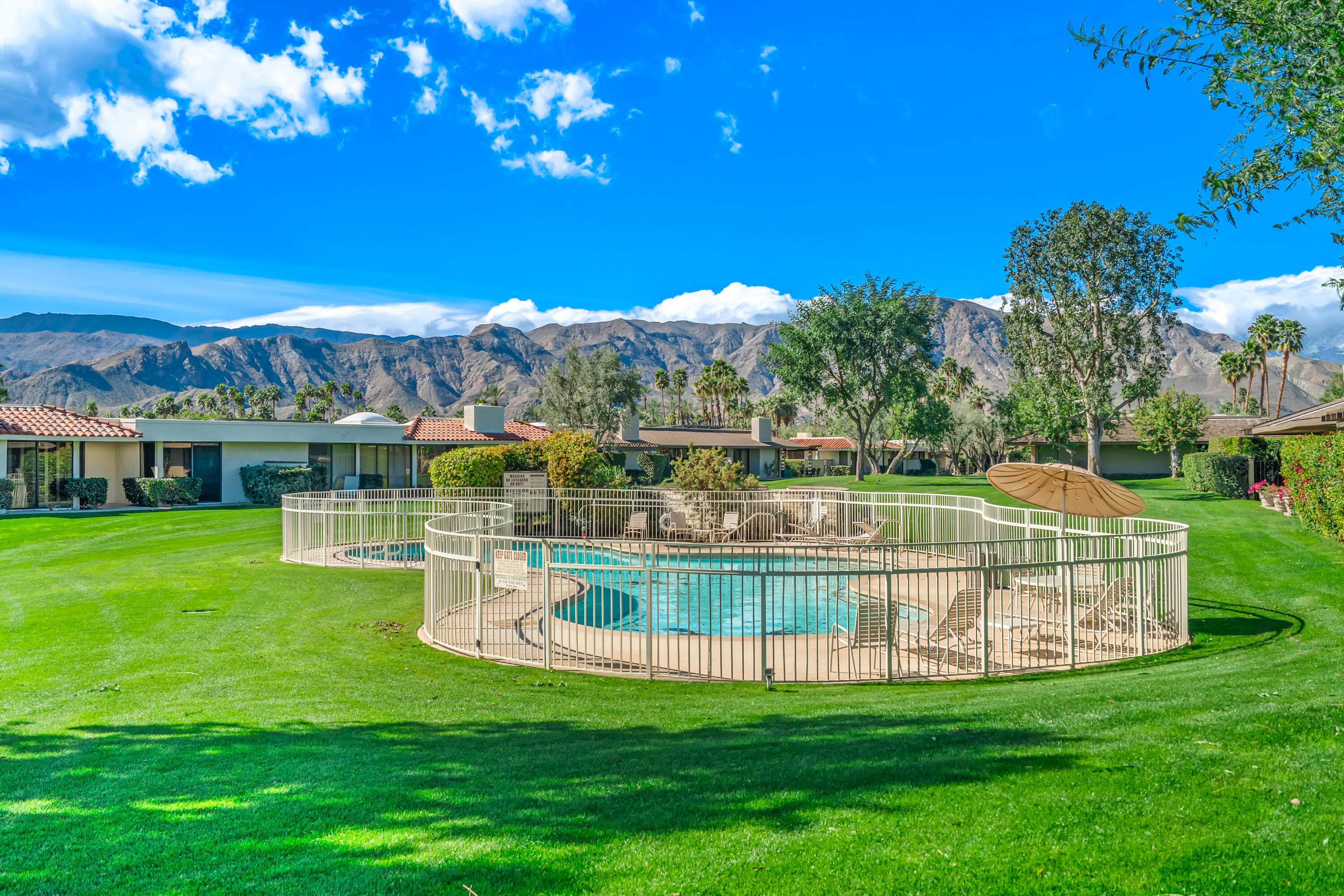 47 Columbia Drive Rancho Mirage, CA 92270 - Photo 57 of 59 a view of a swimming pool with a garden