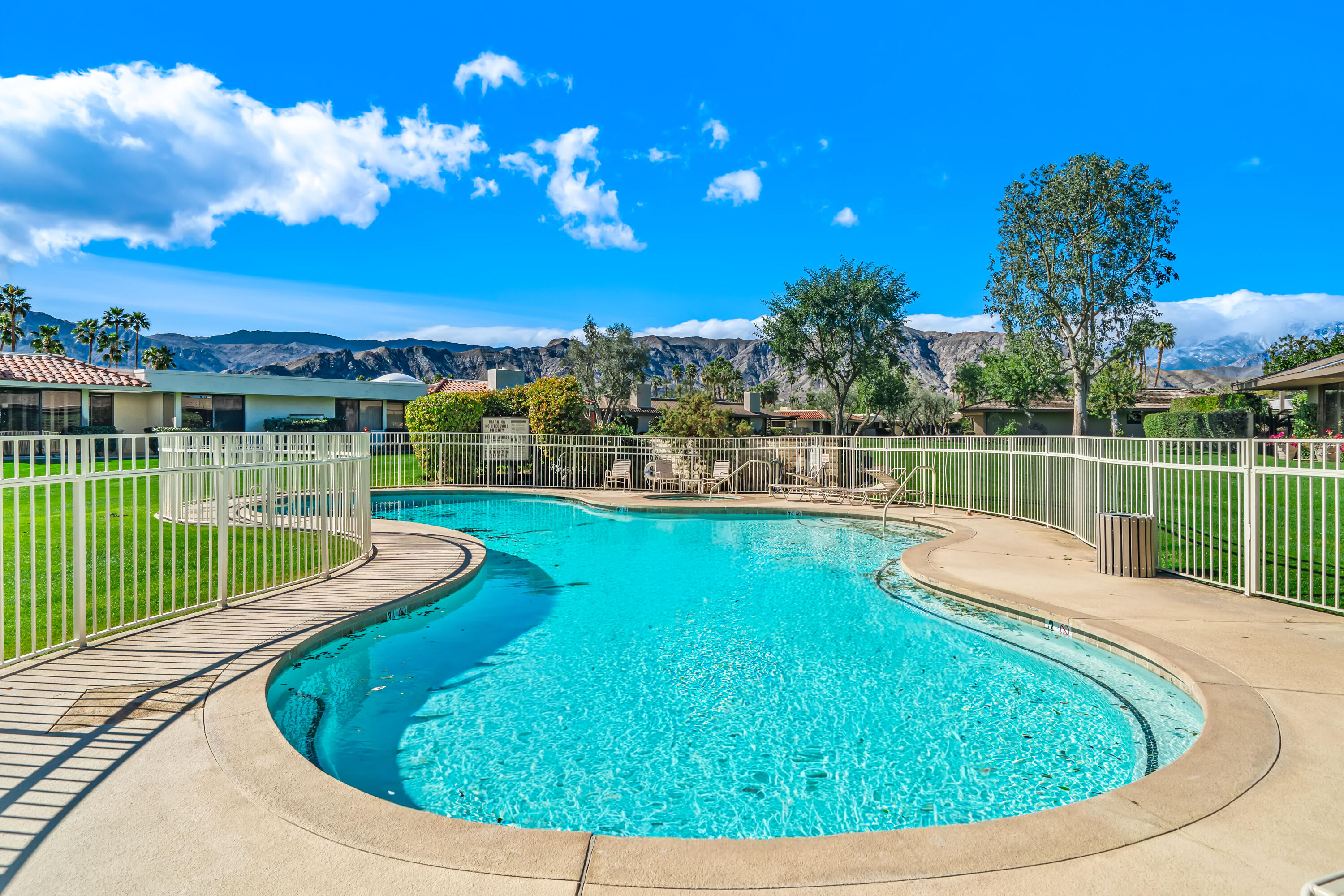 47 Columbia Drive Rancho Mirage, CA 92270 - Photo 58 of 59 a view of a swimming pool with a fountain and a lake view