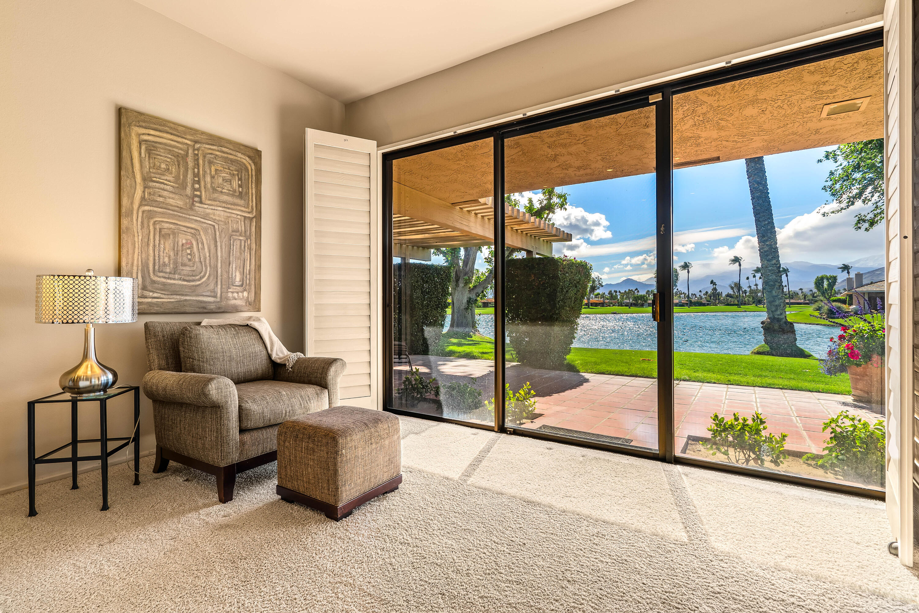 47 Columbia Drive Rancho Mirage, CA 92270 - Photo 9 of 59 a living room with glass top table and sofas