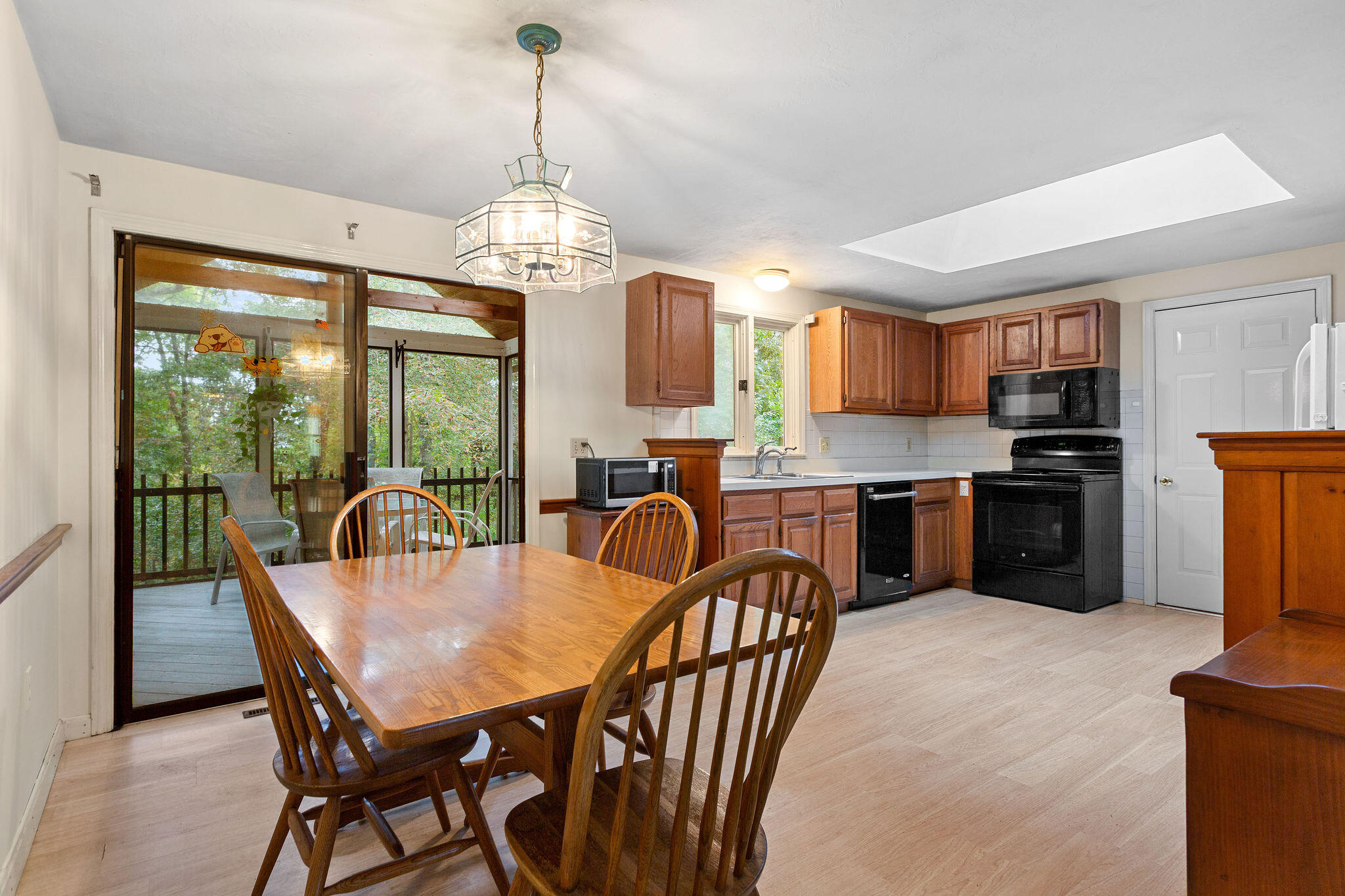 11 Windjammer Road Harwich, MA 02645 - Photo 15 of 29 a dining room with furniture a chandelier and kitchen view
