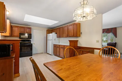 a kitchen with stainless steel appliances a refrigerator sink and cabinets