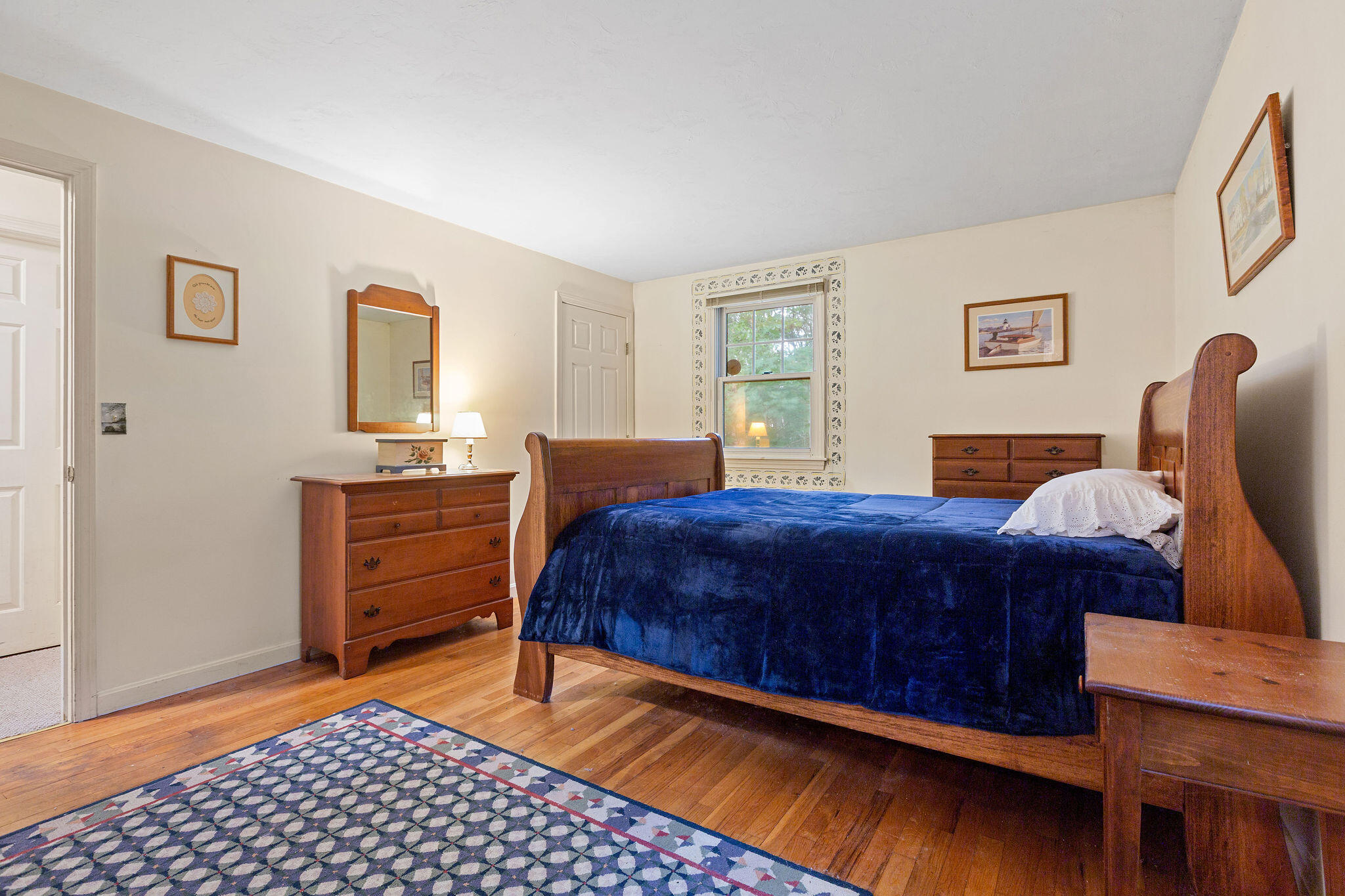 11 Windjammer Road Harwich, MA 02645 - Photo 24 of 29 a bedroom with a bed and wooden floor