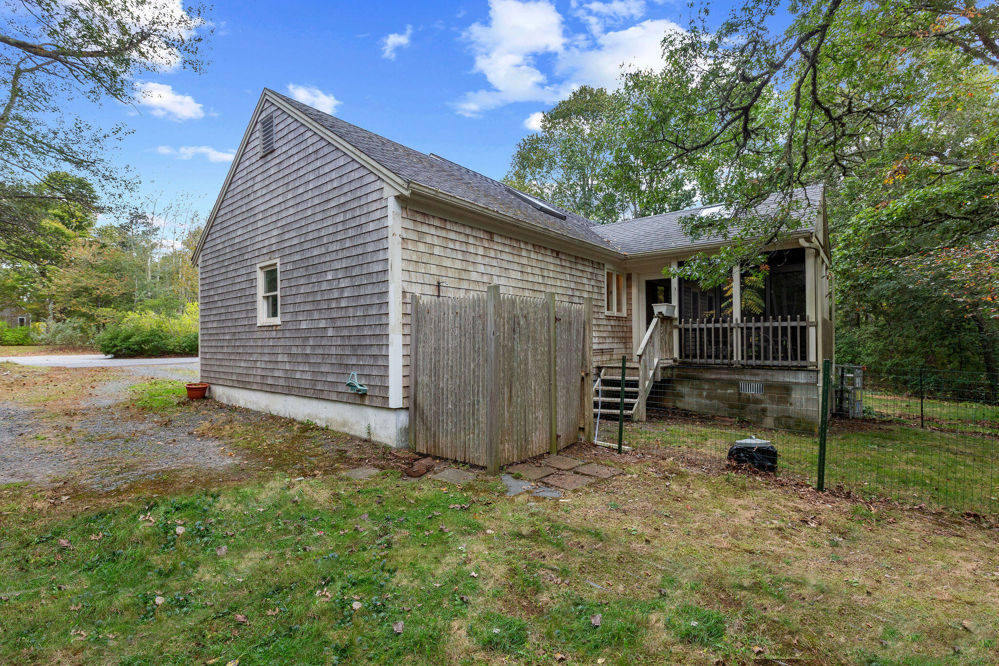 11 Windjammer Road Harwich, MA 02645 - Photo 6 of 29 a view of backyard with small cabin and wooden fence