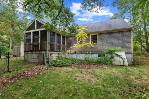 a view of a house with wooden fence