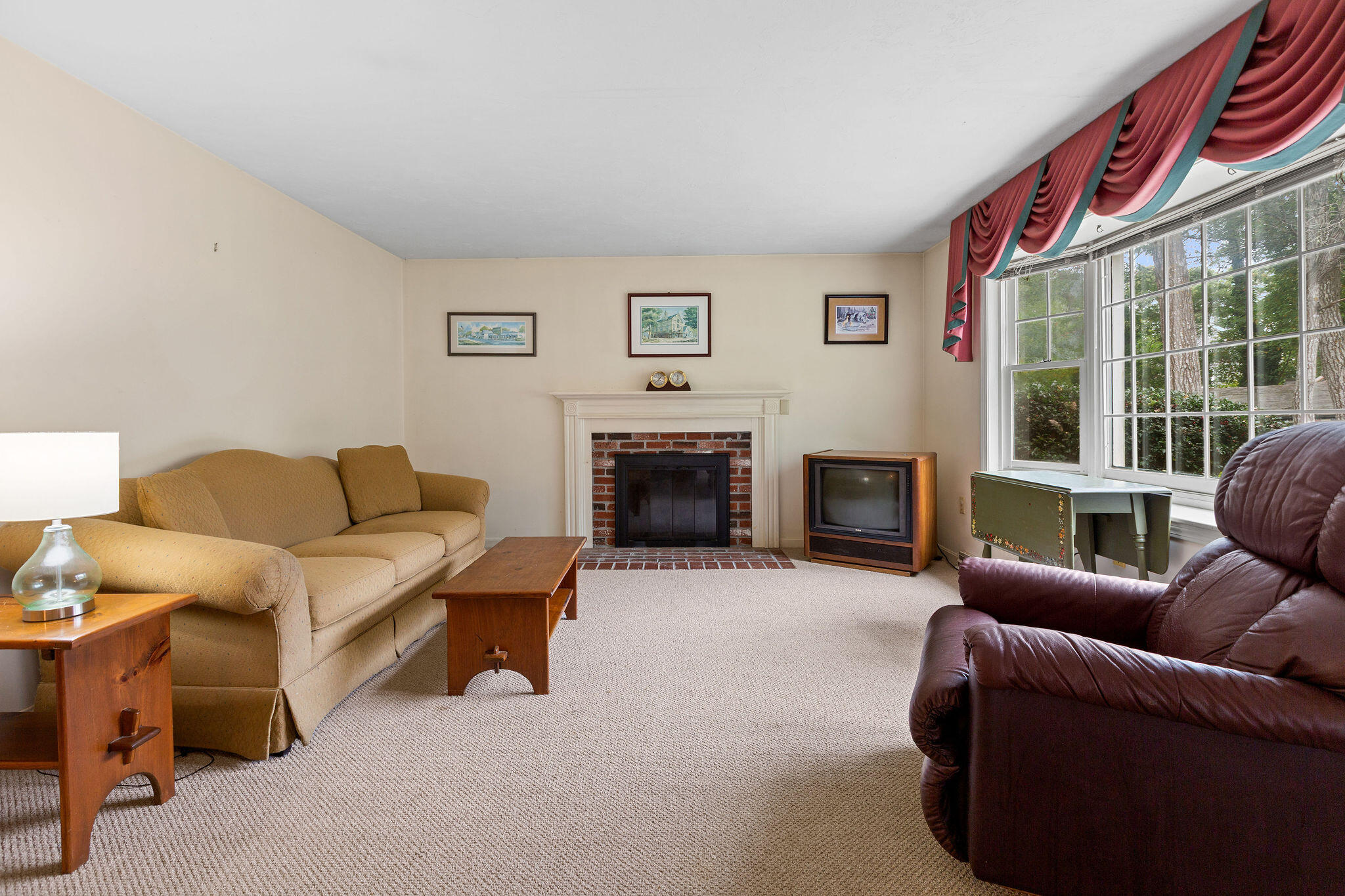 11 Windjammer Road Harwich, MA 02645 - Photo 10 of 29 a living room with furniture a large window and a fireplace