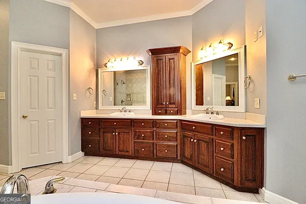a spacious bathroom with a tub sink and mirror
