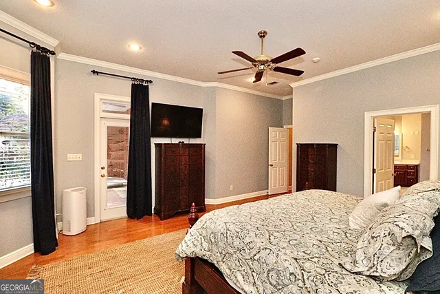 a bedroom with a large bed and a chandelier