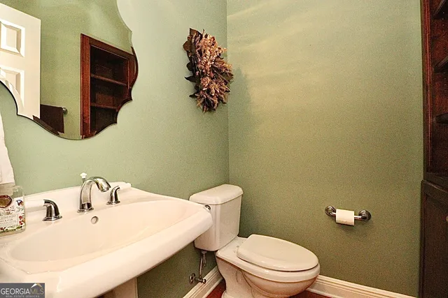 a view of a living room a flat screen tv with kitchen view