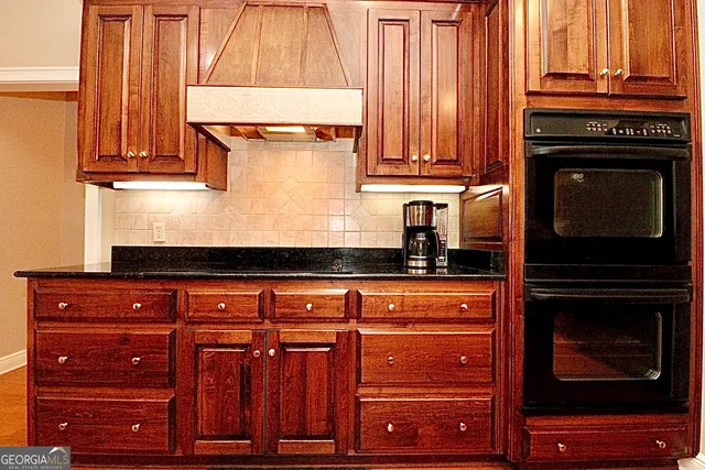 a view of a livingroom with wooden floor and a large window