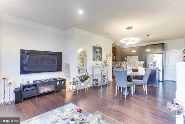 a living room with furniture wooden floor and a table