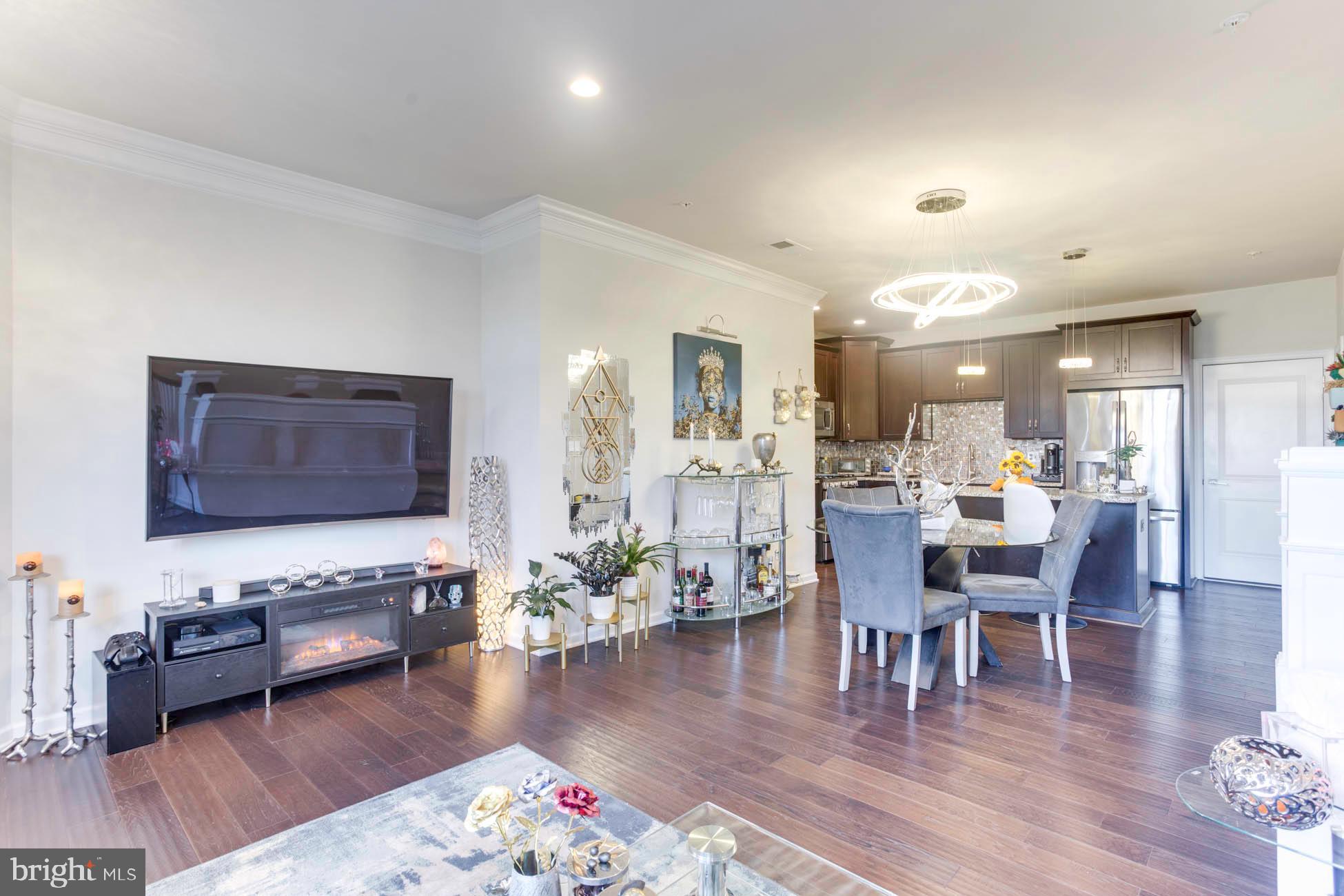 43048 Vernon Ridge Terrace Ashburn, VA 20148 - Photo 12 of 40 a living room with furniture wooden floor and a table